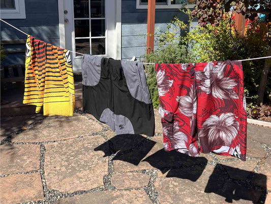 Three types of boardshorts hanging on a clothesline