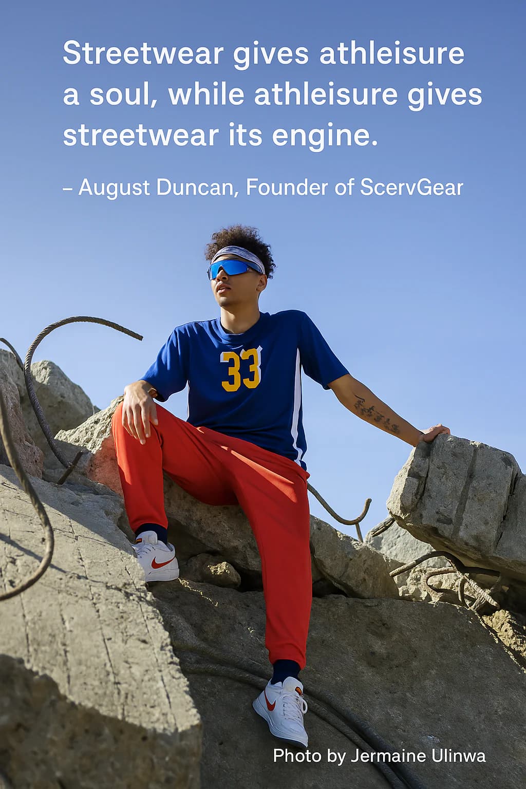 Person wearing athleisure sitting on concrete.