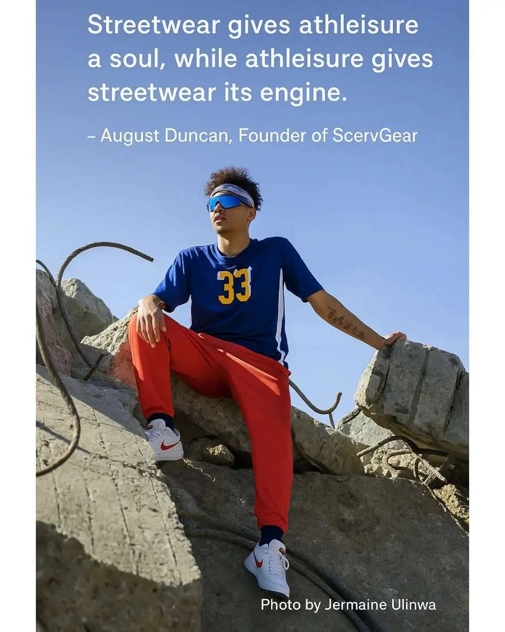 Person wearing athleisure sitting on concrete.