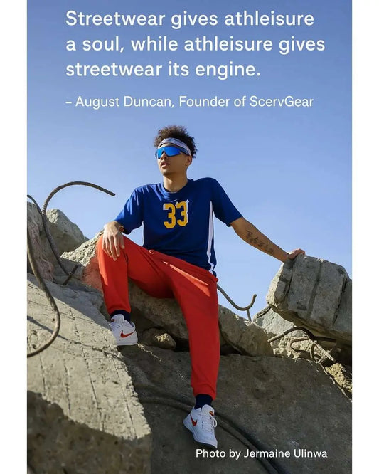 Person wearing athleisure sitting on concrete.