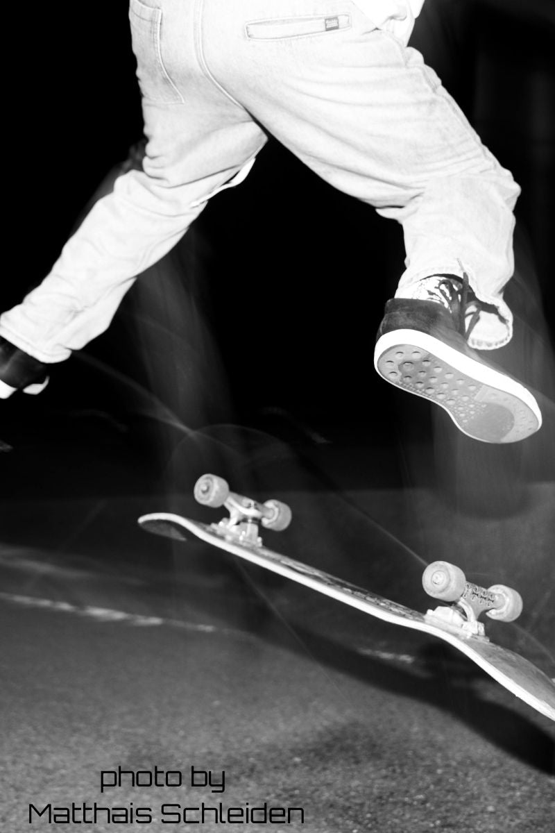Picutre of skater doing a trick in skateboarding jeans 