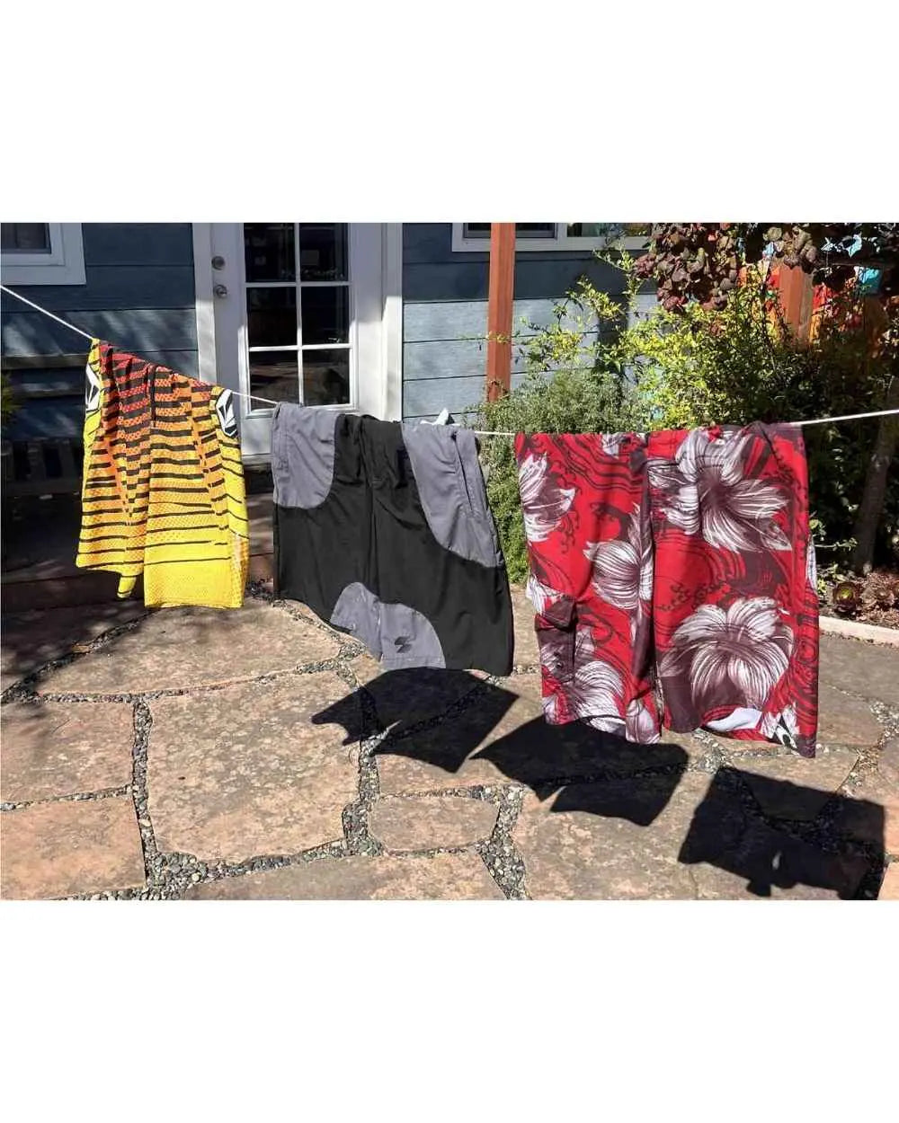 Three types of boardshorts hanging on a clothesline